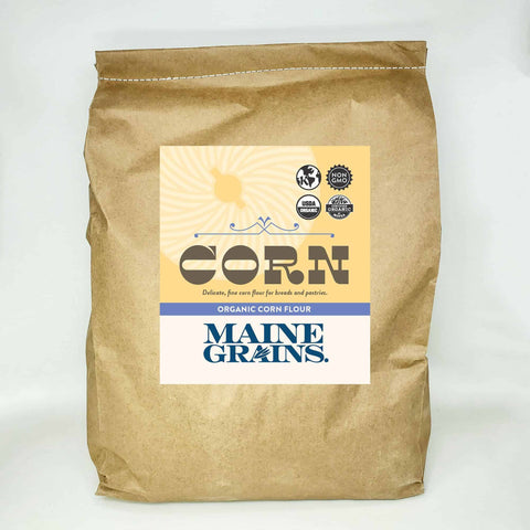A 25# bulk bag of corn flour in a kraft paper bag.