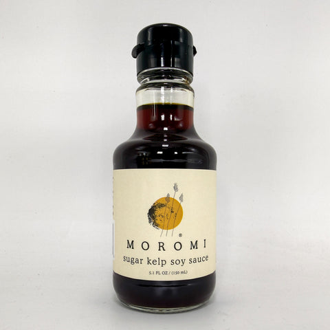 A bottle of MOROMI sugar kelp soy sauce with a cream label and black cap, photographed against a plain light gray background.