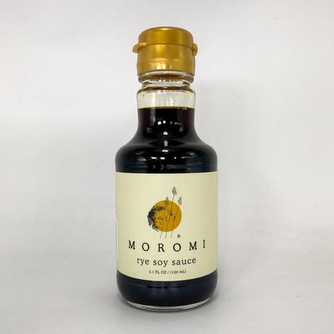 A bottle of Moromi Rye Soy Sauce with a cream-colored label and a gold cap, set against a plain light gray background.