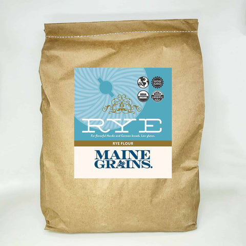 A 25# bulk bag of rye flour in a kraft paper bag.