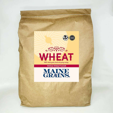 A 25# bulk bag of whole wheat flour in a kraft paper bag.