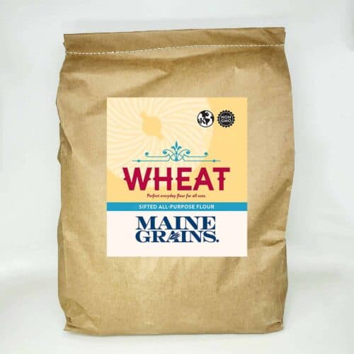 A 25# bulk bag of sifted wheat flour in a kraft paper bag.
