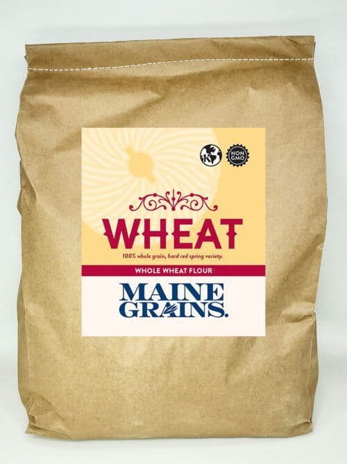 A 25# bulk bag of whole wheat flour in a kraft paper bag.