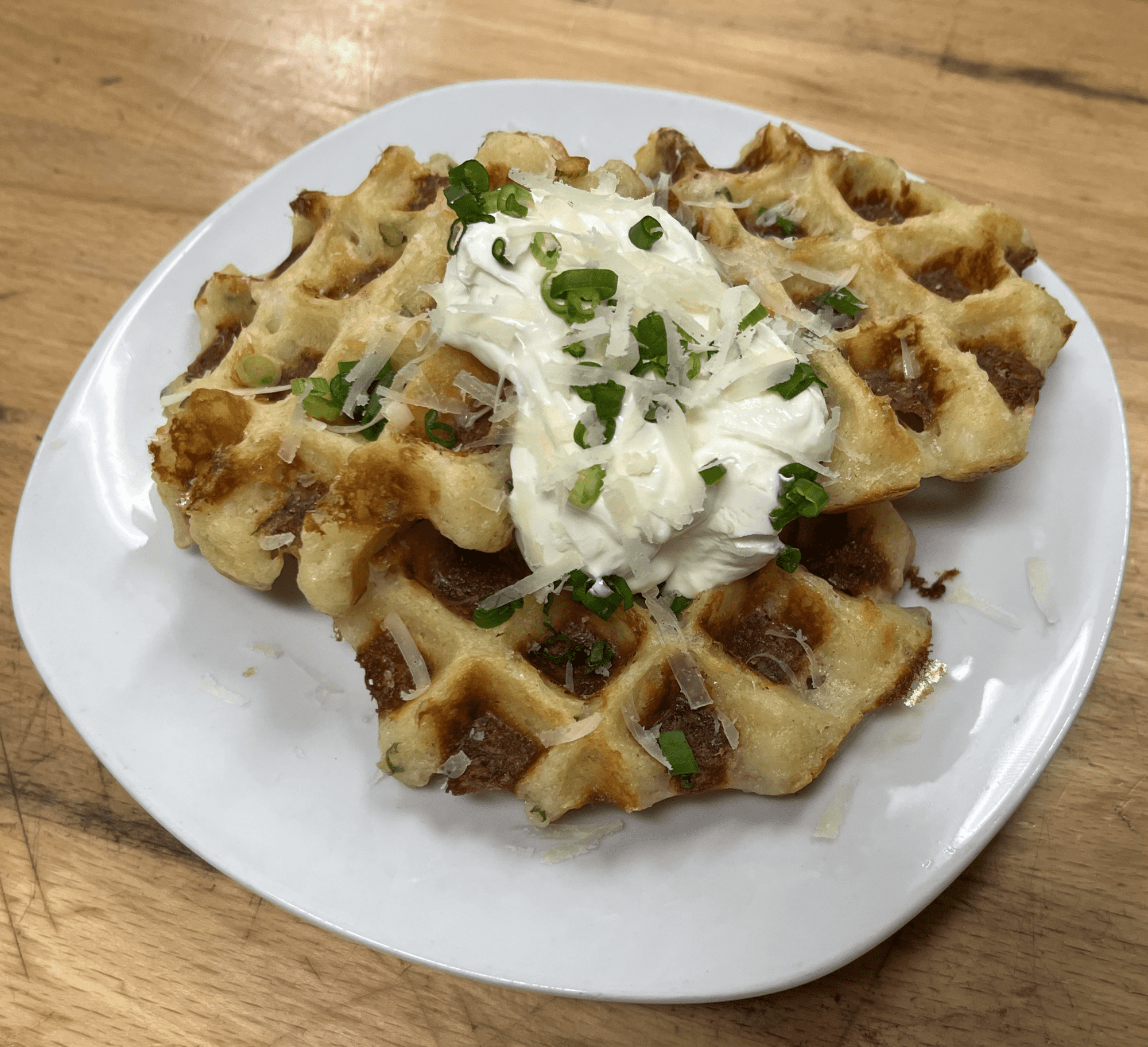 Mashed Potato Waffles with Sour Cream, Sliced Scallions, and Shredded Parmesan