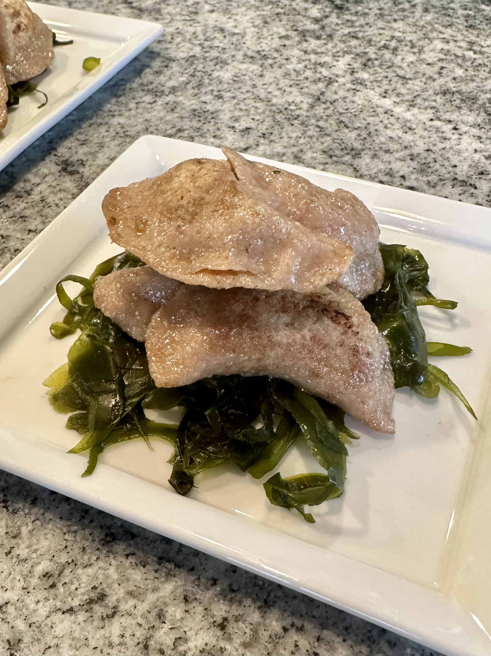 Spinach and pork dumplings over Maine seaweed