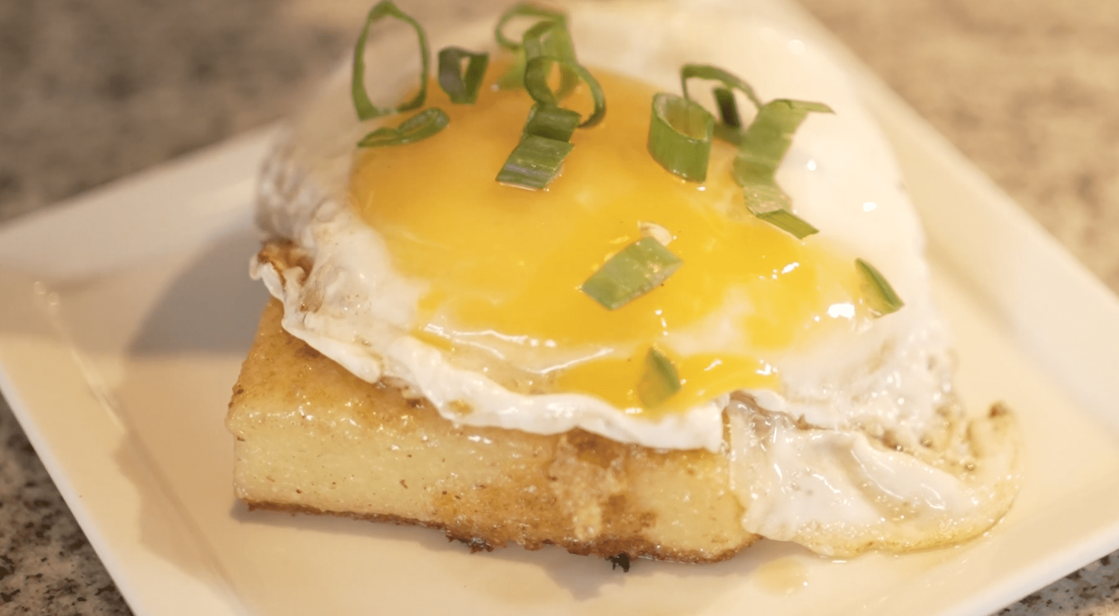 Maine Grains Polenta Cake topped with a sunny-side up egg